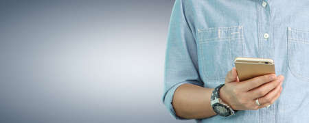 Man hand holding smartphone device and touching screen. isolated with clipping pathの写真素材