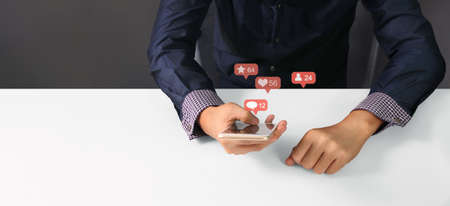 Hand holding smartphone device and touching screen, searching or social networks conceptの写真素材