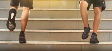 Runner feet running on road closeup on a shoeの写真素材