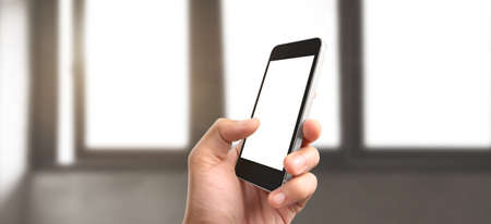 Hand holding smartphone device and touching screenの写真素材