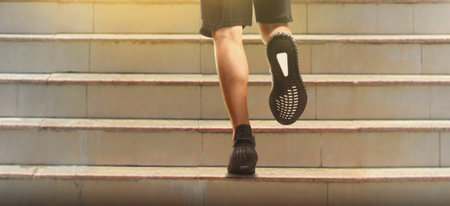 Runner feet running on road closeup on a shoe