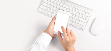 Hand holding smartphone device and touching screen
