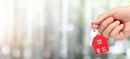 Real estate agent handing over house keys in handの写真素材