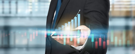 Smartphone in hand and plan graph growth and increase of chart positive indicators in his business