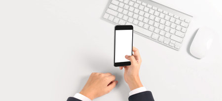 Hand holding smartphone device and touching screen