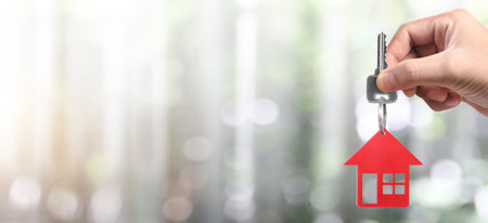 Real estate agent handing over house keys in handの写真素材