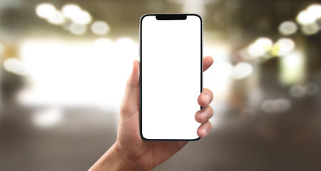 Hand holding smartphone device and touching screen
