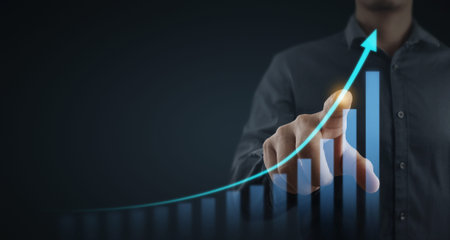 Businessman plan graph growth and increase of chart positive indicators in his businessの写真素材