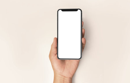 Hand holding smartphone device and touching screenの写真素材