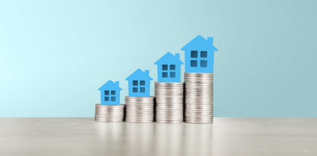 Model of detached miniature house mock up on coins. property real estate investment concept