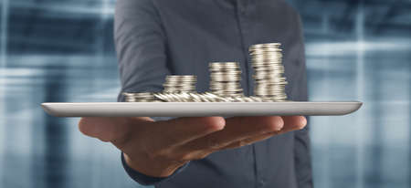 Coin and wealth concept. Loads of money on glass representing tabletの写真素材