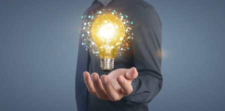 Hand of holding illuminated light bulb, idea, innovation inspiration concept