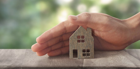Model of detached miniature house  mock up in hand. property real estate investment conceptの写真素材