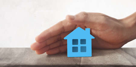 Model of detached miniature house  mock up in hand. property real estate investment conceptの写真素材