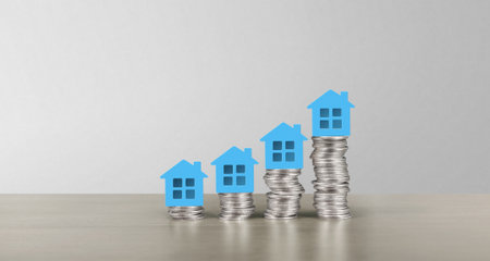 Model of detached miniature house mock up on coins. property real estate investment conceptの写真素材