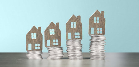 Model of detached miniature house mock up on coins. property real estate investment conceptの写真素材