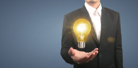 Hand of holding illuminated light bulb, idea, innovation inspiration concept