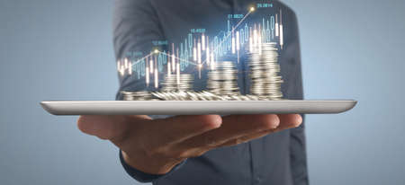 Coin and wealth concept. Loads of money on glass representing tabletの写真素材