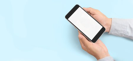 Hand holding smartphone device and touching screenの写真素材