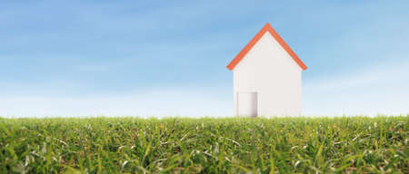 Model house in the meadow with grass in the eveningの写真素材