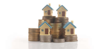 Model of detached miniature house mock up on coins. property real estate investment conceptの写真素材