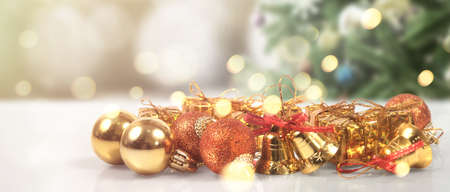 Decorated Christmas tree hanging on pine branches gift boxes  and ornamentsの写真素材
