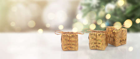 Decorated Christmas tree hanging on pine branches gift boxes  and ornamentsの写真素材