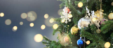 Decorated Christmas tree hanging on pine branches  and ornamentsの写真素材