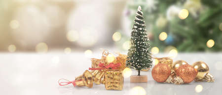Decorated Christmas tree hanging on pine branches gift boxes  and ornamentsの写真素材