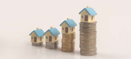 Model of detached miniature house mock up on coins. property real estate investment conceptの写真素材