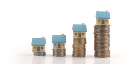 Model of detached miniature house mock up on coins. property real estate investment conceptの写真素材