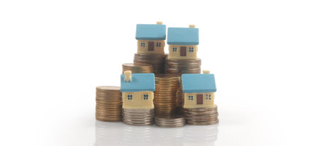 Model of detached miniature house mock up on coins. property real estate investment conceptの写真素材
