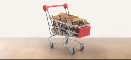 Toy shopping cart with coins and Consumer society trendの写真素材