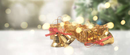 Decorated Christmas tree hanging on pine branches gift boxes  and ornamentsの写真素材