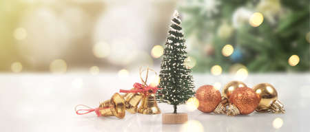 Decorated Christmas tree hanging on pine branches gift boxes  and ornamentsの写真素材