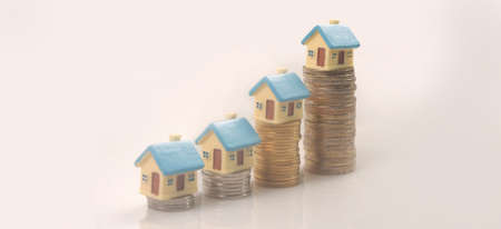 Model of detached miniature house mock up on coins. property real estate investment conceptの写真素材