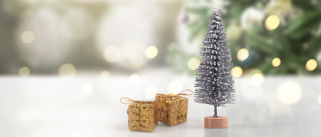 Decorated Christmas tree hanging on pine branches gift boxes  and ornamentsの写真素材