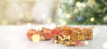 Decorated Christmas tree hanging on pine branches gift boxes  and ornamentsの写真素材