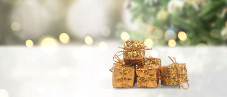 Decorated Christmas tree hanging on pine branches gift boxes  and ornamentsの写真素材