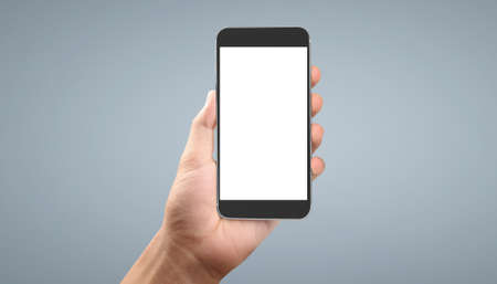 Hand holding smartphone device and touching screenの写真素材