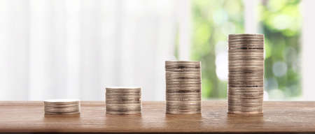 Stack of a coin with trading graph, financial investment conceptの写真素材