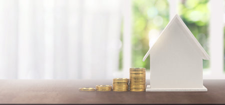 Model of detached miniature house mock and coins. property real estate investment conceptの写真素材