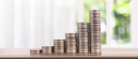 Stack of a coin with trading graph, financial investment concept