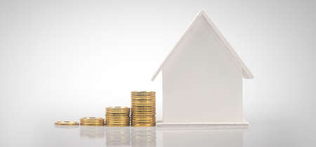 Model of detached miniature house mock and coins. property real estate investment conceptの写真素材