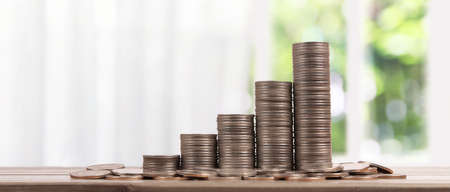 Stack of a coin with trading graph, financial investment conceptの写真素材