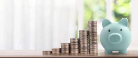 Stack of a coin with trading graph, financial investment concept. and Piggy bankの写真素材
