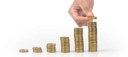 Stack coin in hand with trading graph, financial investment conceptの写真素材