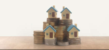 Model of detached miniature house mock and coins. property real estate investment conceptの写真素材