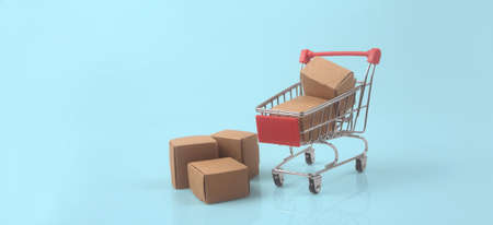 Toy shopping cart with boxes shopping and delivery concept. Consumer society trendの写真素材