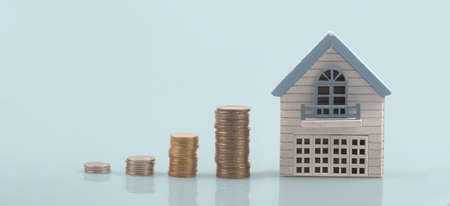 Model of detached miniature house mock and coins. property real estate investment conceptの写真素材